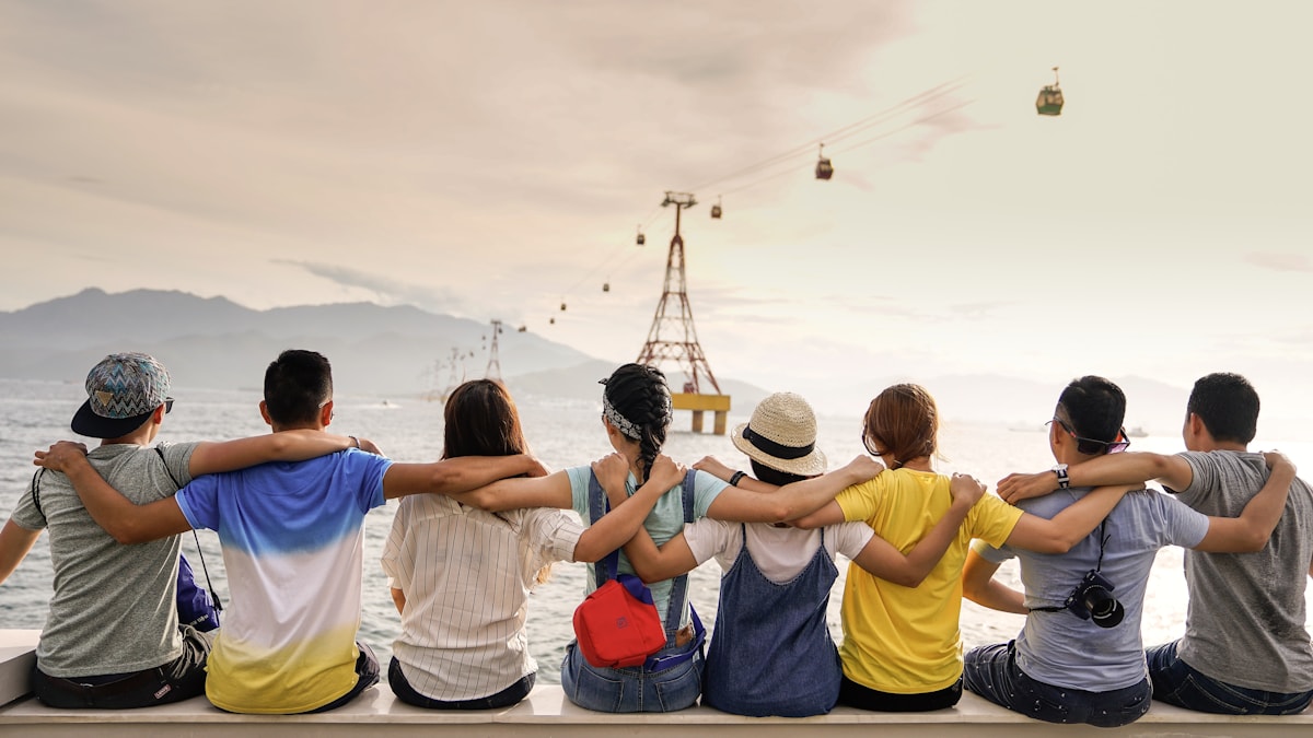 Friends laughing together outdoors, staying present in the moment